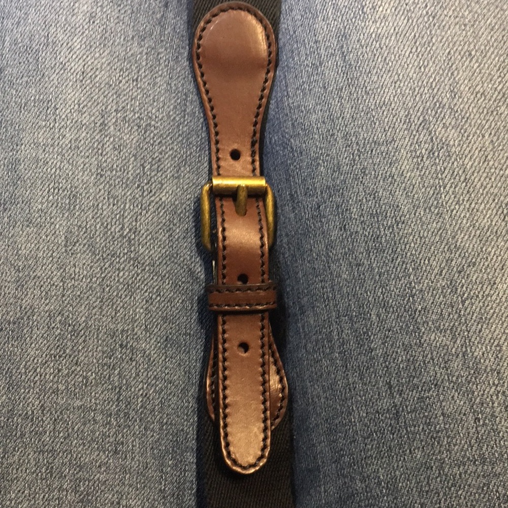 Club Monaco Noelle black web belt with brown leather detail and brass buckle.